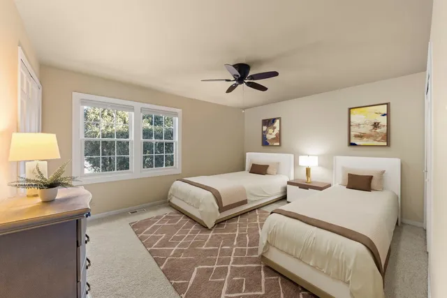 a bedroom with two beds and a window