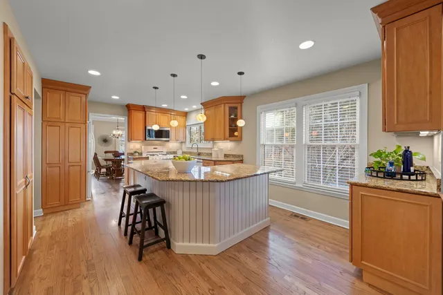a kitchen with counter top space a sink appliances and cabinets