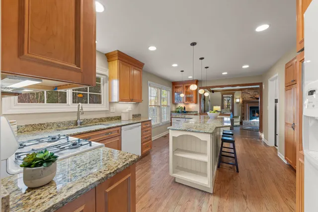 a kitchen with stainless steel appliances granite countertop a sink and cabinets