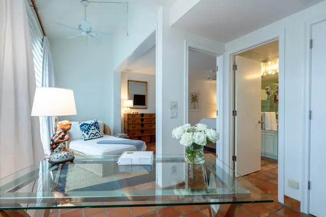 a view of a patio with table and chairs potted plants with floor to ceiling window