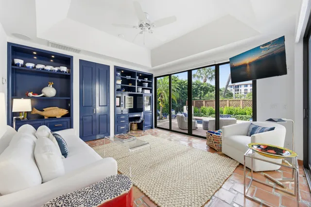 a bedroom with furniture and a large window