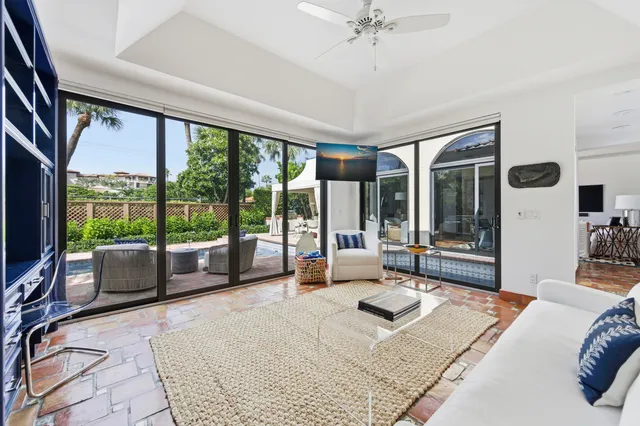 a bedroom with a large bed and large windows