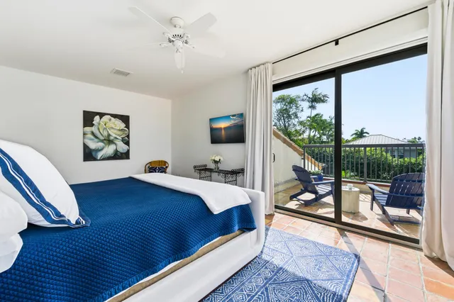 a bed room with a bed window and a chair