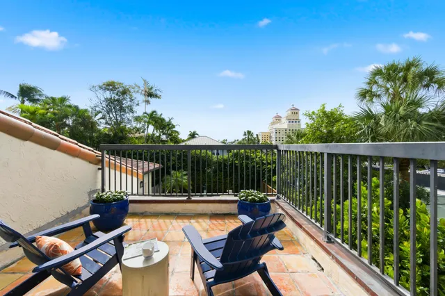 a bedroom with a bed a mirror on dresser and a flat screen tv