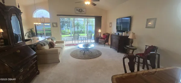 a living room with furniture and a floor to ceiling window