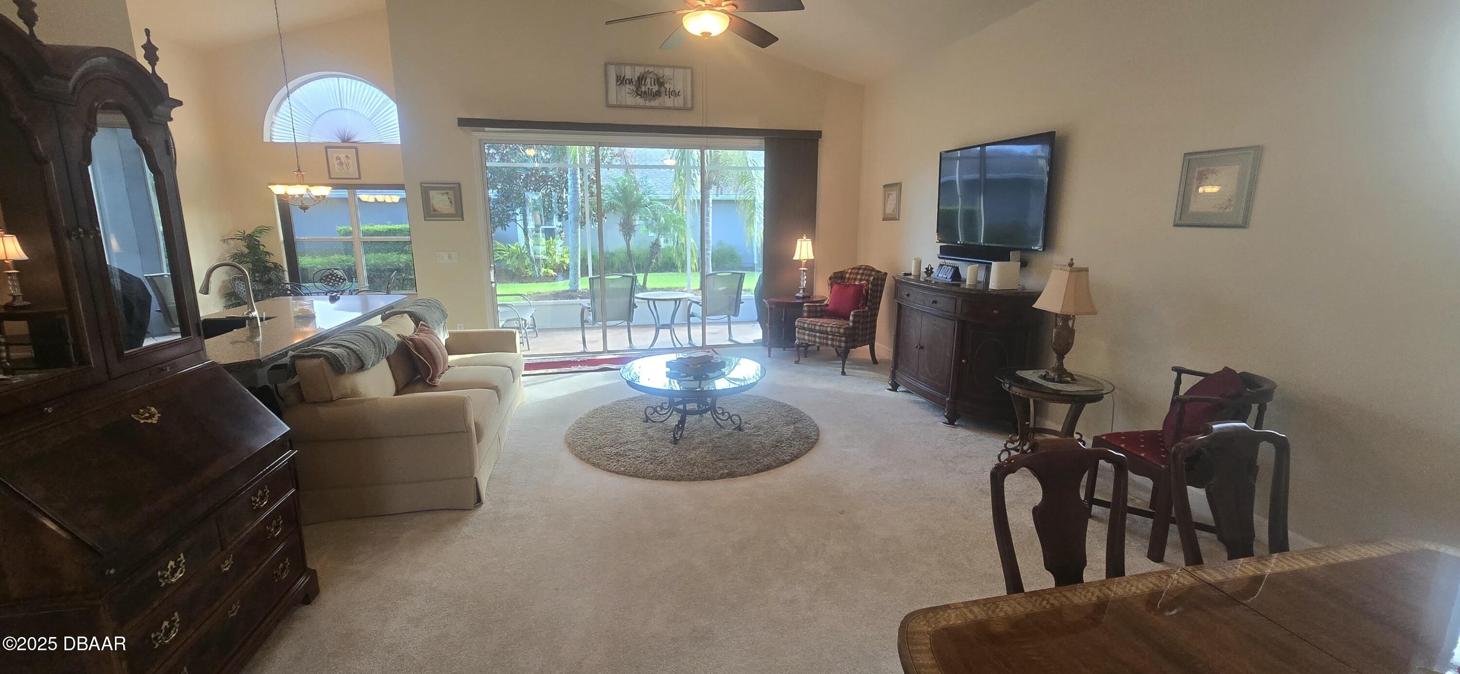 1279 Royal Pointe Lane Ormond Beach, FL 32174 - Photo 15 of 24 a living room with furniture and a floor to ceiling window