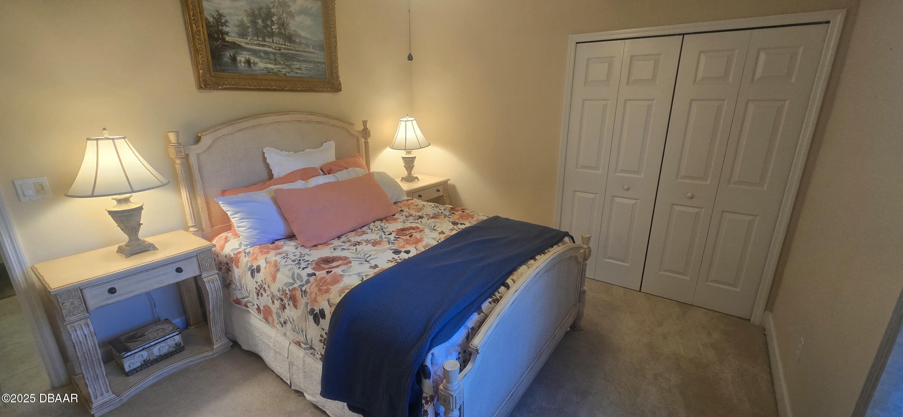 1279 Royal Pointe Lane Ormond Beach, FL 32174 - Photo 17 of 24 a bed sitting in a bedroom next to a window