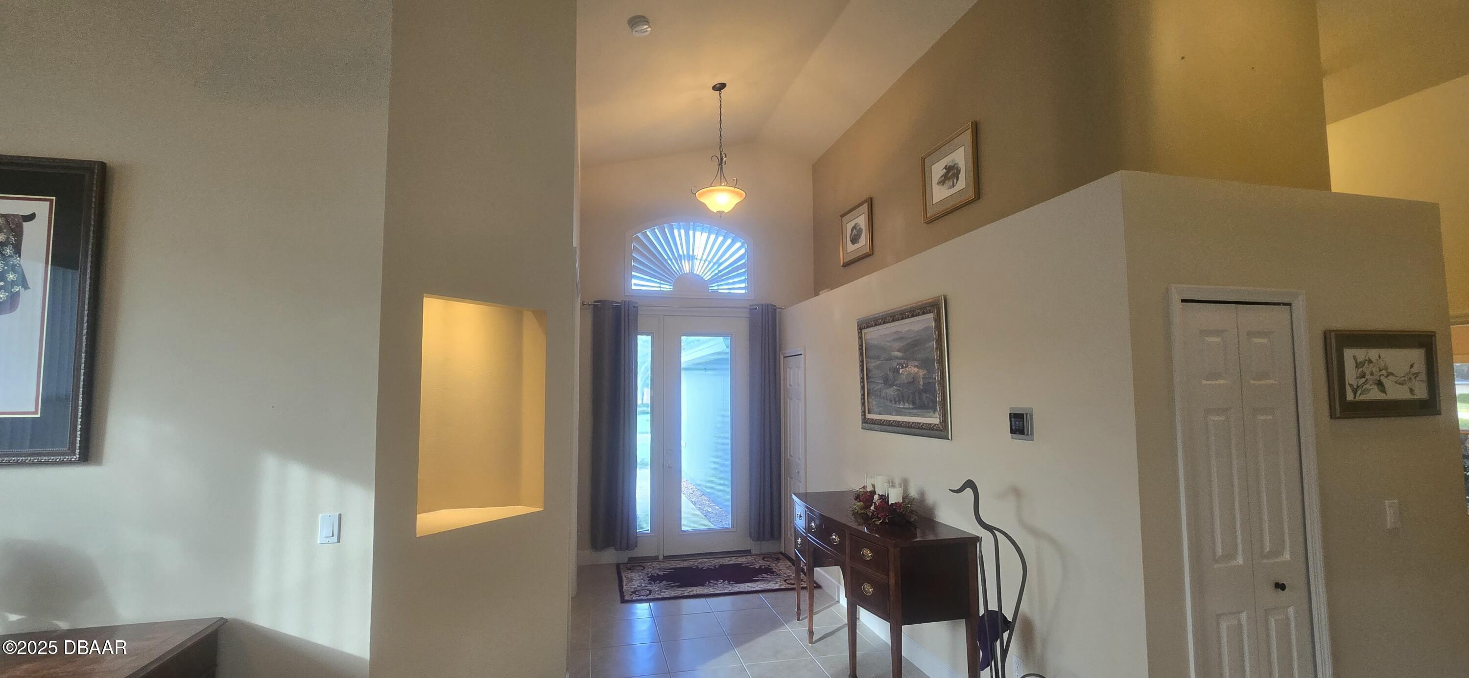 1279 Royal Pointe Lane Ormond Beach, FL 32174 - Photo 3 of 24 a view of a hallway with furniture and windows