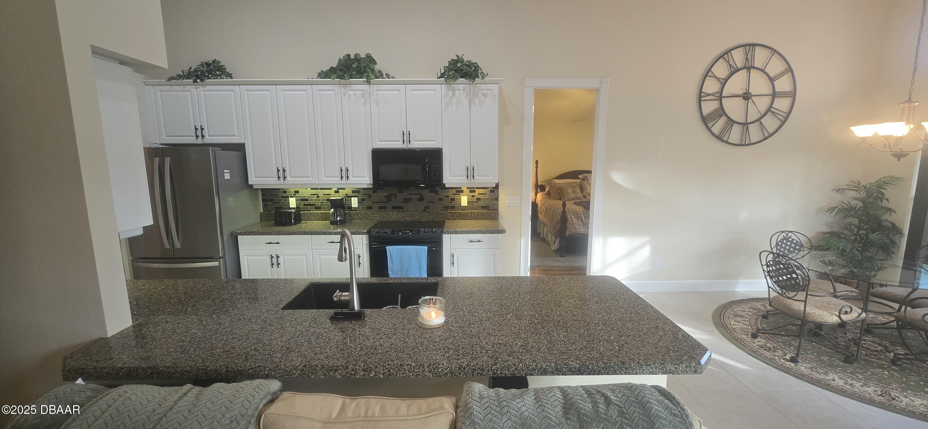 1279 Royal Pointe Lane Ormond Beach, FL 32174 - Photo 6 of 24 a living room with furniture and a flat screen tv