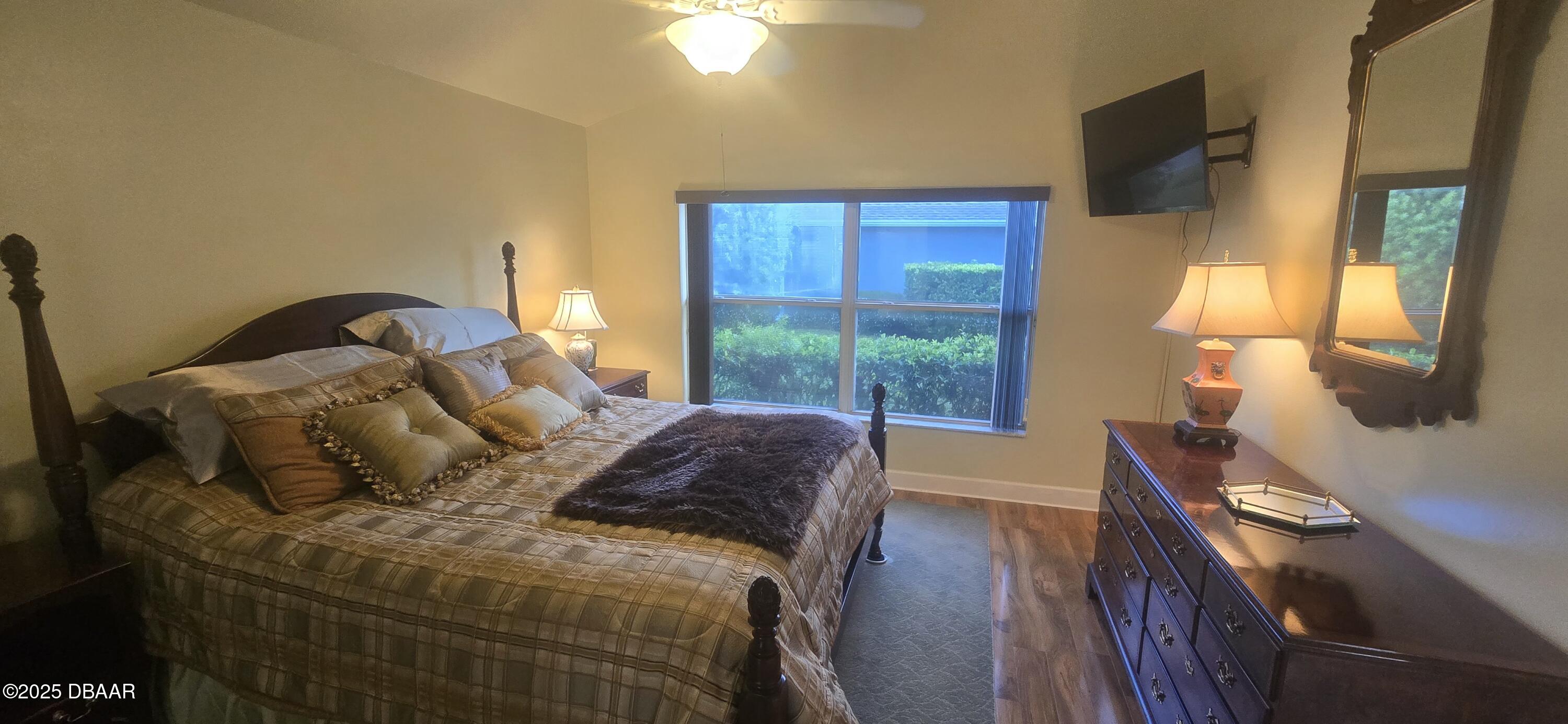 1279 Royal Pointe Lane Ormond Beach, FL 32174 - Photo 8 of 24 a bed sitting in a bedroom next to a window