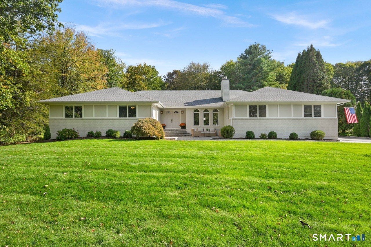 66 Heather Road Monroe, CT 06468 - Photo 1 of 40 a front view of a house with a yard table and chairs