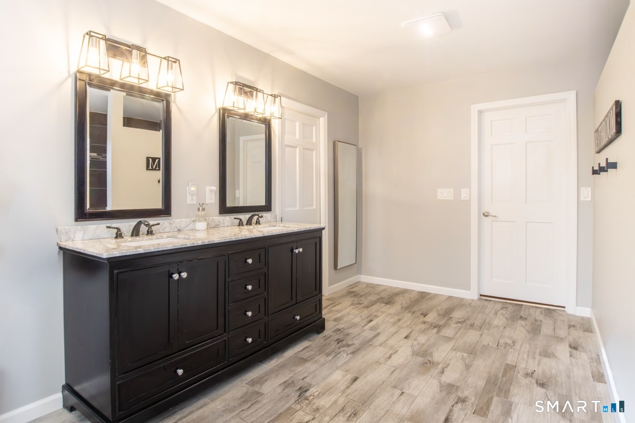 66 Heather Road Monroe, CT 06468 - Photo 22 of 40 a bathroom with a double vanity sink and a mirror