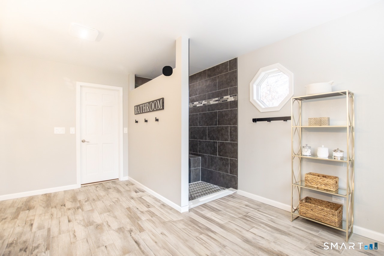 66 Heather Road Monroe, CT 06468 - Photo 23 of 40 an empty room with cabinet and mirror