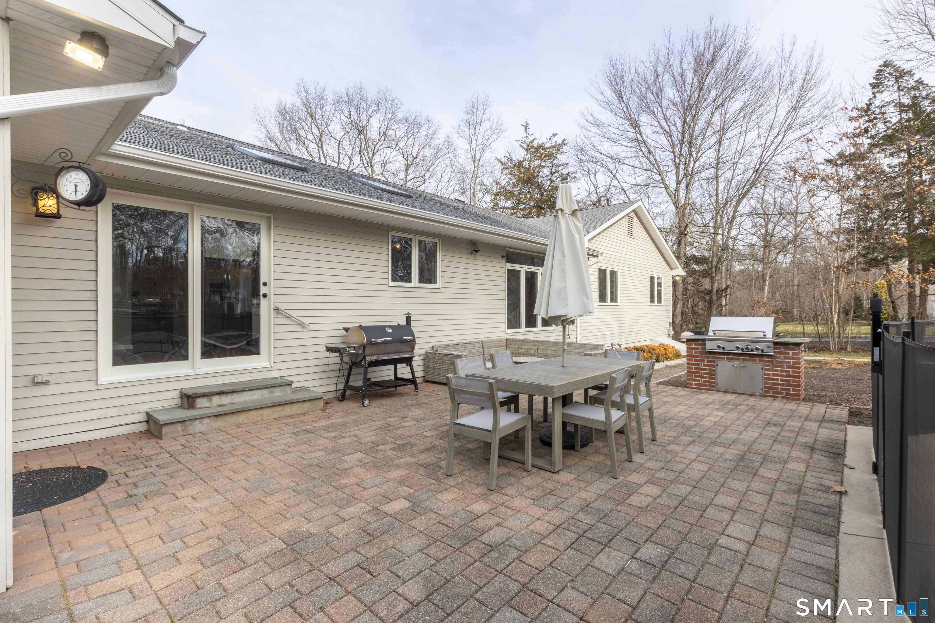 66 Heather Road Monroe, CT 06468 - Photo 34 of 40 a backyard of a house with dining table and chairs
