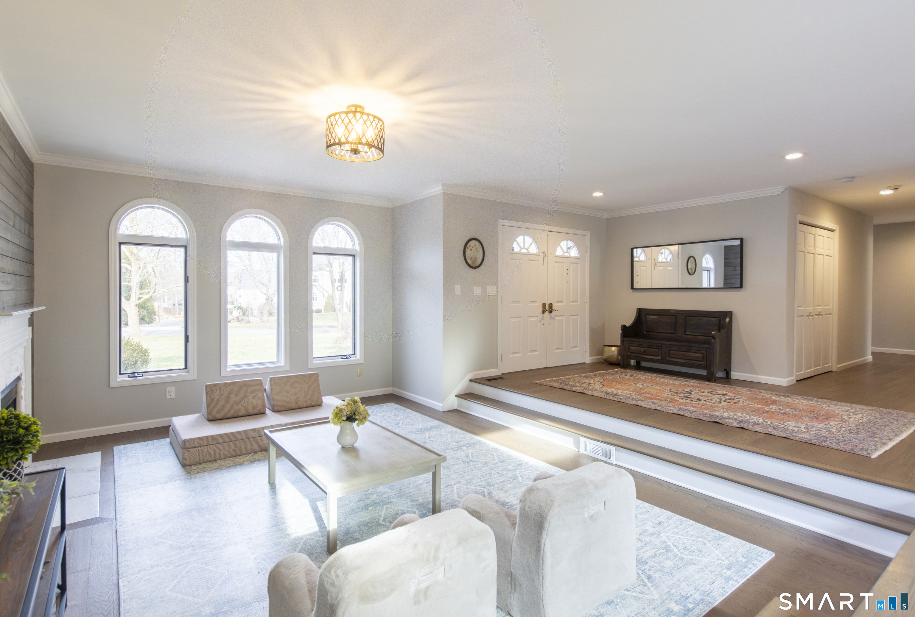 66 Heather Road Monroe, CT 06468 - Photo 7 of 40 a spacious bedroom with a bed a couch and a chandelier