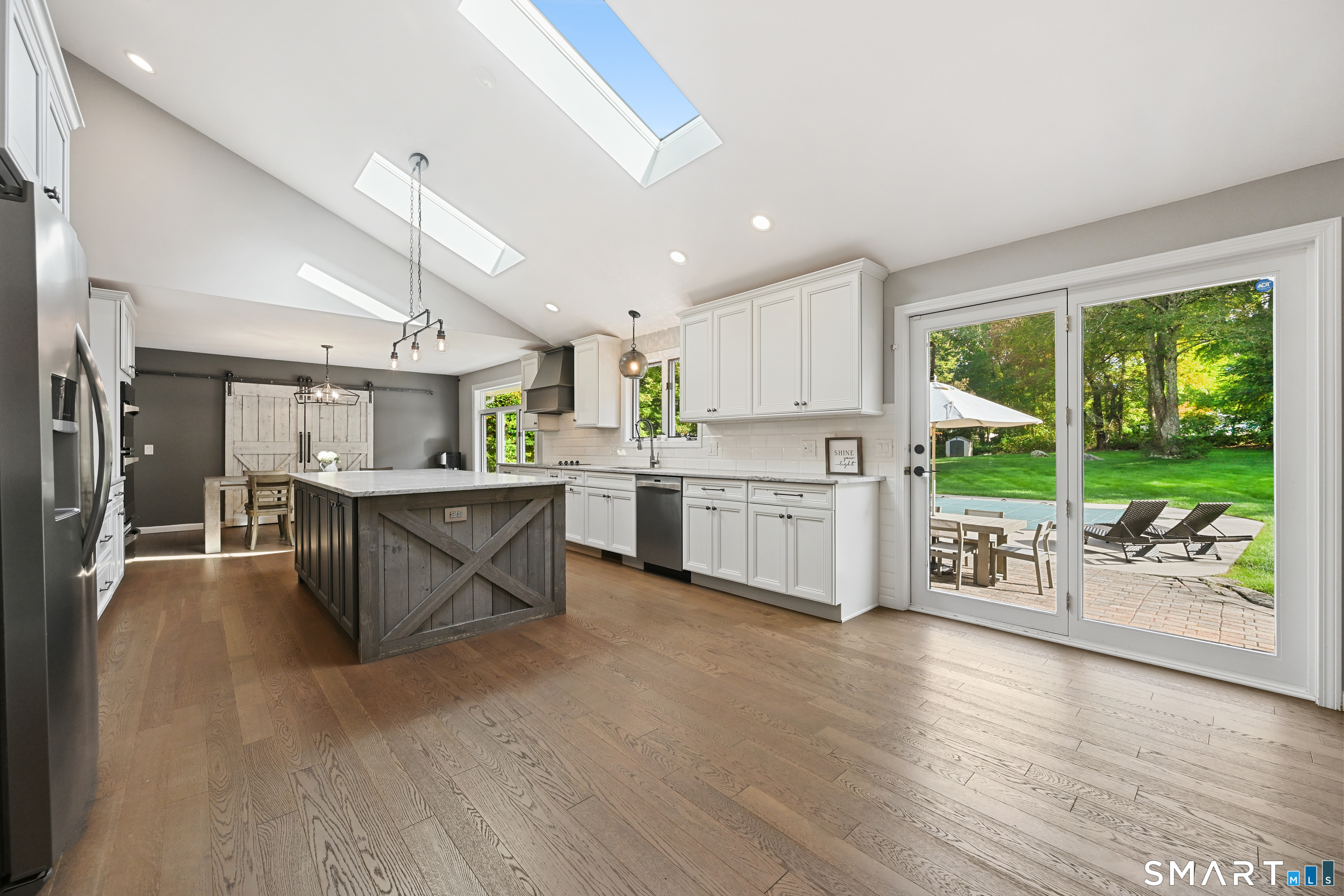 66 Heather Road Monroe, CT 06468 - Photo 9 of 40 a kitchen with stainless steel appliances kitchen island wooden cabinets and wooden floors
