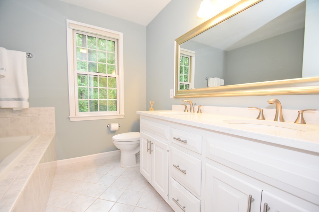 16 Wayside Inn Road Framingham, MA 01701 - Photo 22 of 30 a spacious bathroom with a granite countertop sink a toilet and a bathtub