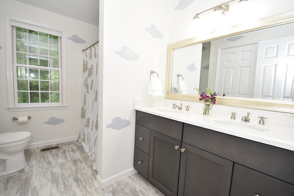 16 Wayside Inn Road Framingham, MA 01701 - Photo 23 of 30 a bathroom with a double vanity sink toilet and a mirror