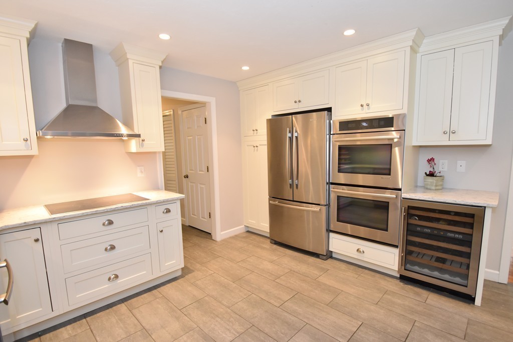 16 Wayside Inn Road Framingham, MA 01701 - Photo 3 of 30 a kitchen with stainless steel appliances white cabinets and a refrigerator