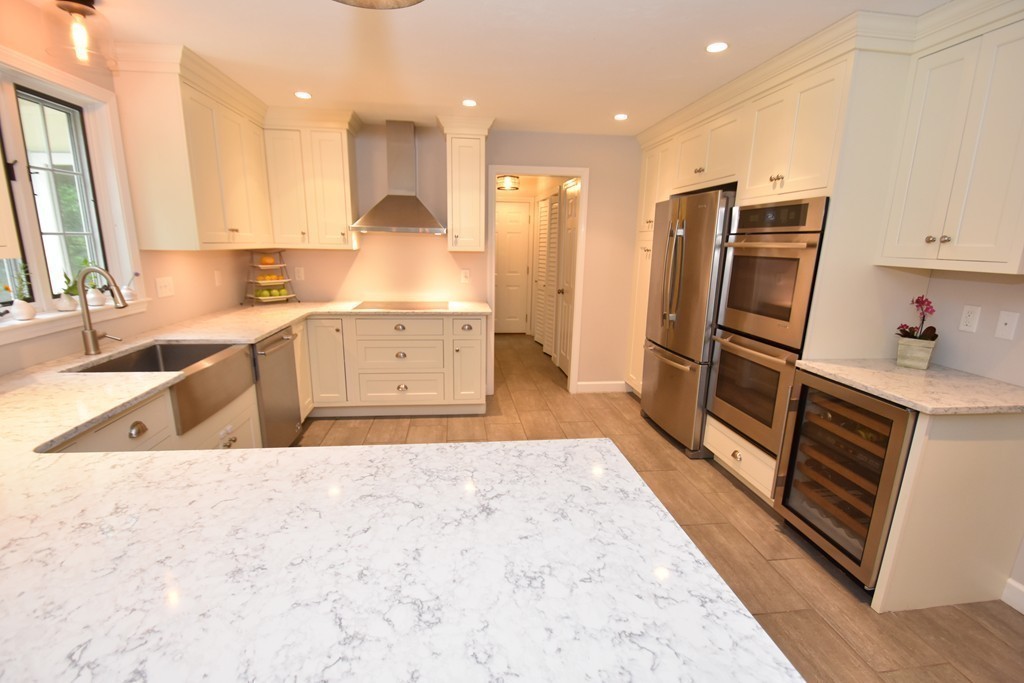 16 Wayside Inn Road Framingham, MA 01701 - Photo 4 of 30 a kitchen with granite countertop a refrigerator and a sink