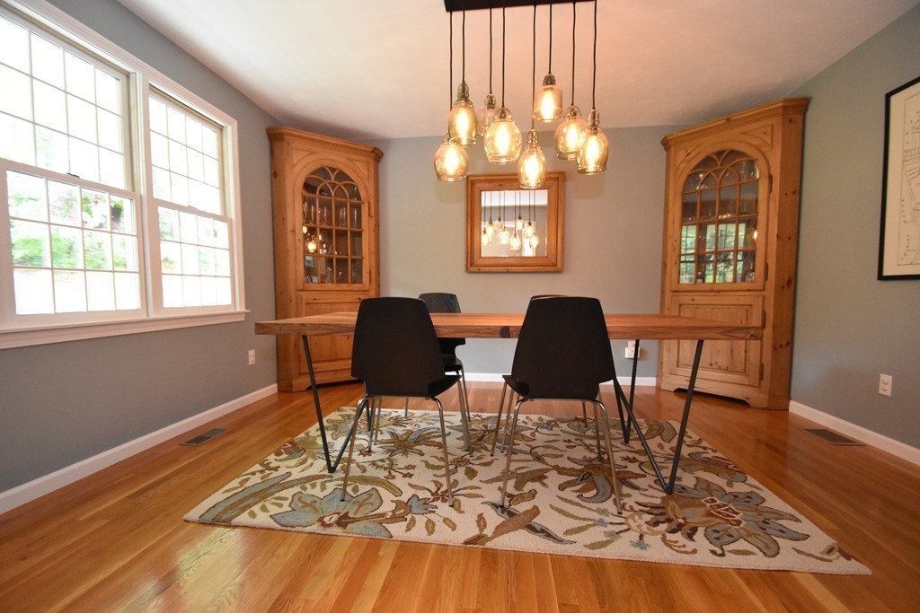 16 Wayside Inn Road Framingham, MA 01701 - Photo 6 of 30 a view of a dining room with furniture a chandelier and wooden floor