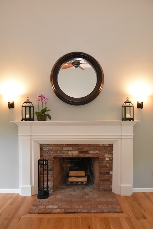 16 Wayside Inn Road Framingham, MA 01701 - Photo 9 of 30 a living room with a fireplace and a wooden floor