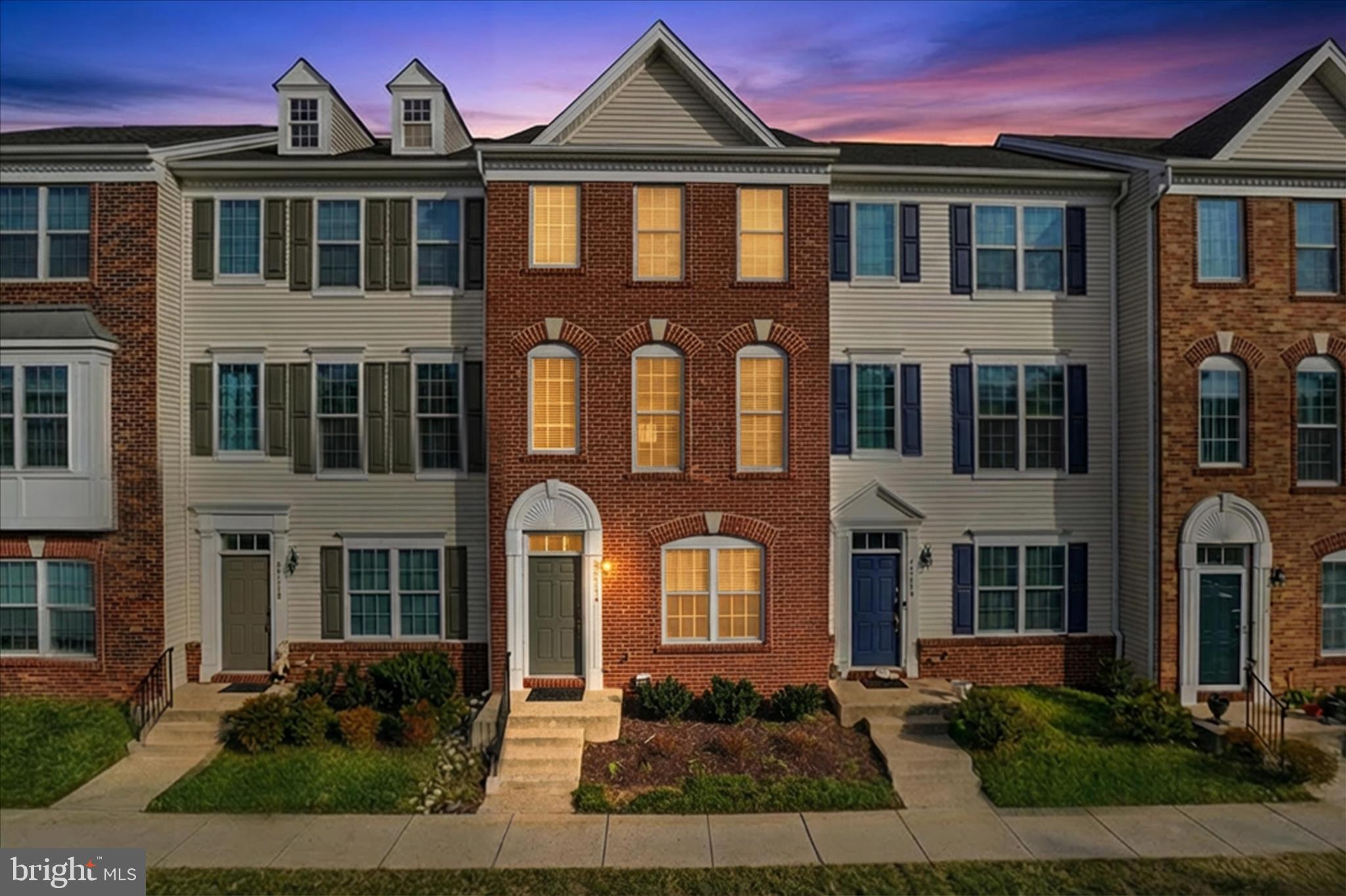 25114 Monteith Terrace Chantilly, VA 20152 - Photo 1 of 46 a front view of a residential apartment building with a yard