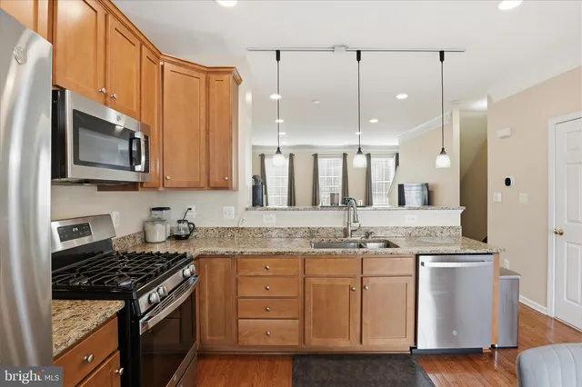 a kitchen with a sink stove and microwave