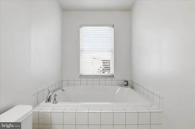 a white bath tub sitting next to a window