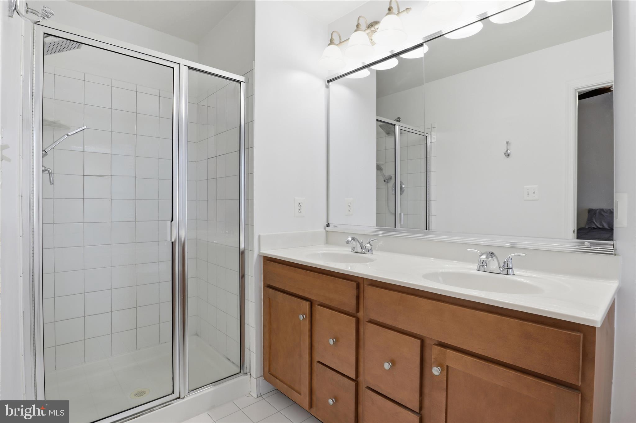 25114 Monteith Terrace Chantilly, VA 20152 - Photo 31 of 46 a bathroom with a double vanity sink a mirror and shower