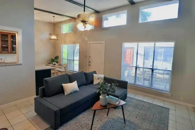 a living room with furniture and a chandelier