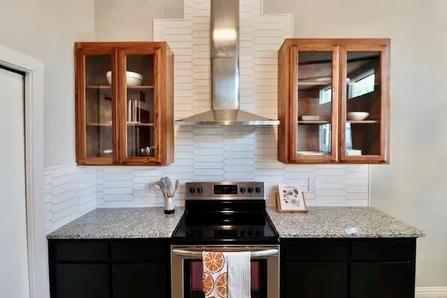 a kitchen with granite countertop cabinets a sink and a stove