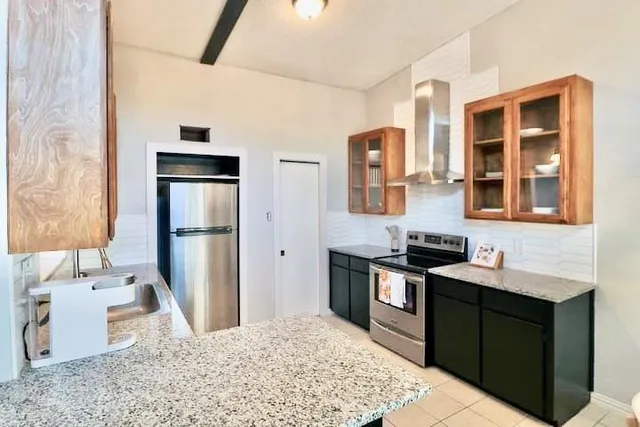 a kitchen with a sink stove and refrigerator