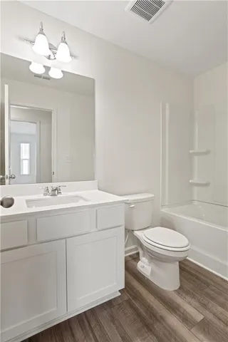 a bathroom with a double vanity sink mirror and toilet
