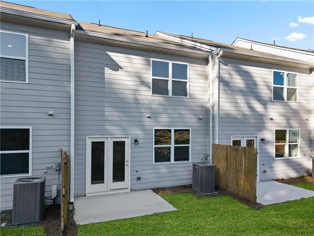 a view of a house with brick walls and a yard