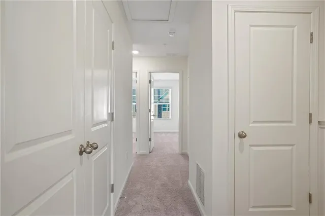 a view of a hallway with a wooden door
