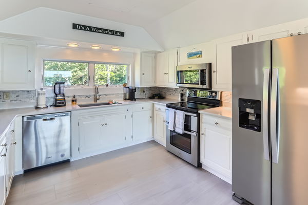 217 Barnes Road Oak Bluffs, MA 02557 - Photo 19 of 60 a kitchen with a sink stove and refrigerator