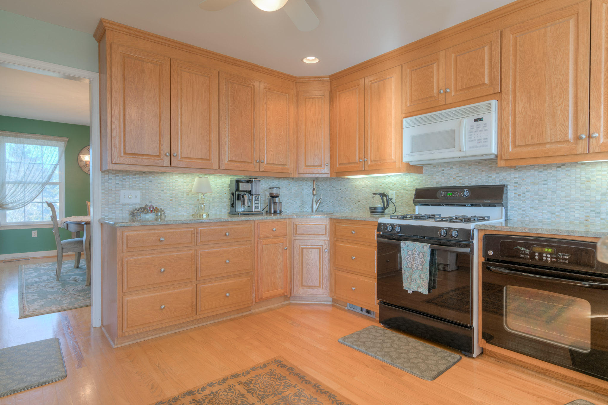 1675 Union Valley Road Riner, VA 24149 - Photo 13 of 50 a kitchen with granite countertop a stove top oven and cabinets