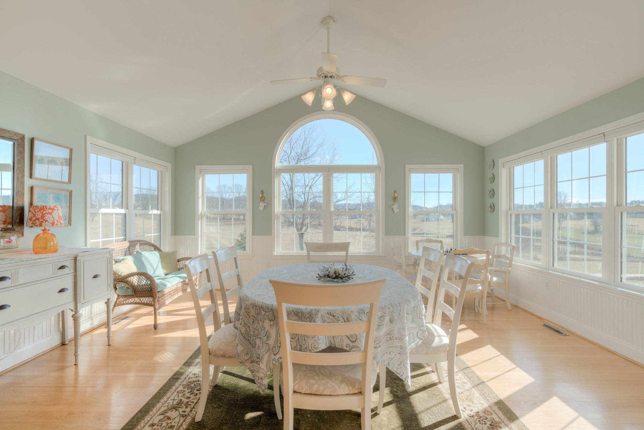 1675 Union Valley Road Riner, VA 24149 - Photo 17 of 50 a dining room with wooden floor a chandelier a glass table and chairs
