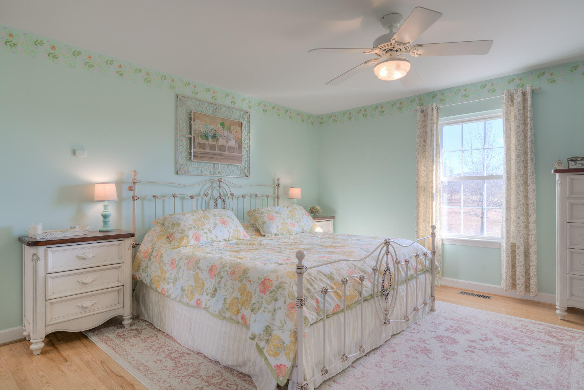 1675 Union Valley Road Riner, VA 24149 - Photo 24 of 50 a bedroom with a large bed and a chandelier