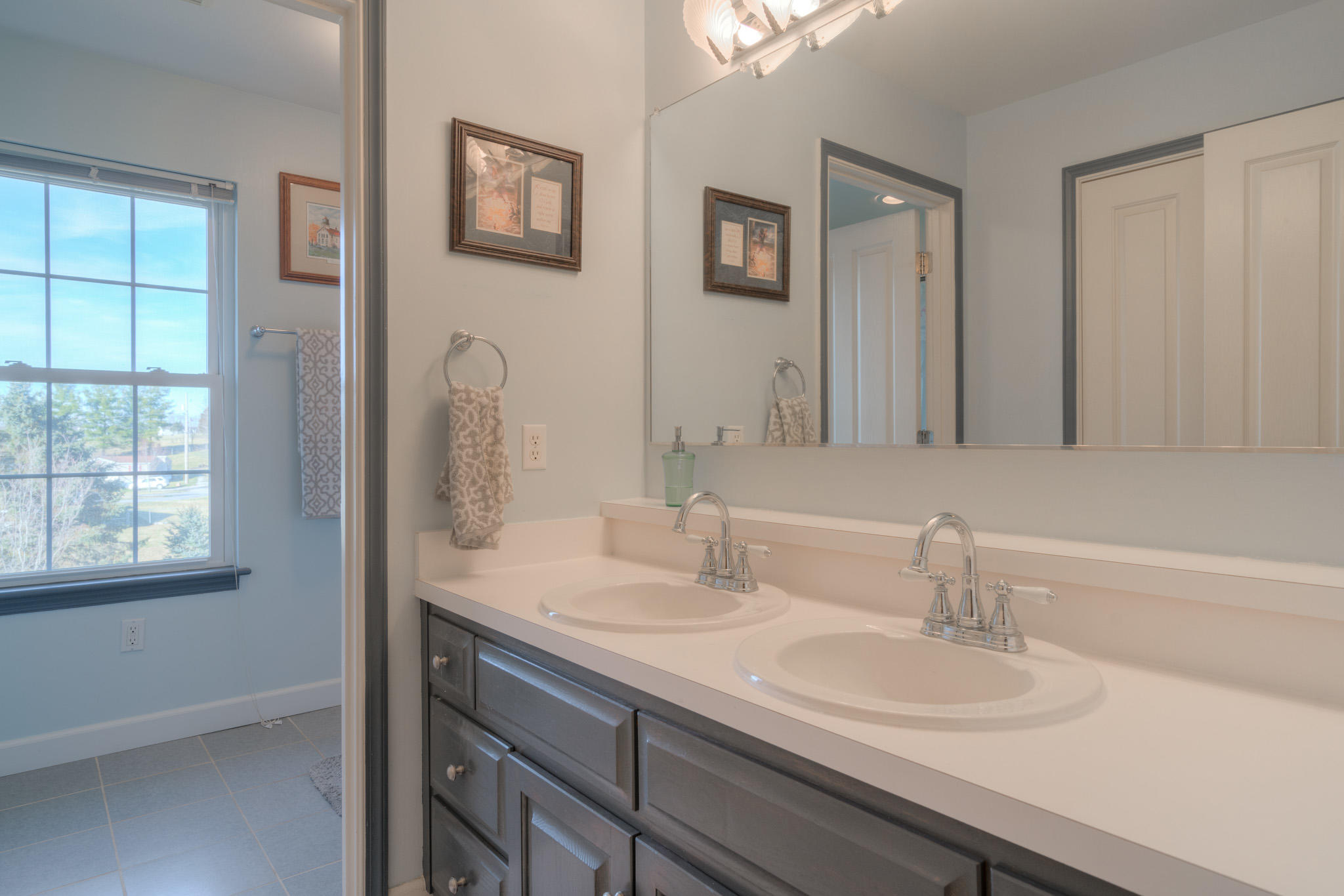 1675 Union Valley Road Riner, VA 24149 - Photo 31 of 50 a bathroom with double vanity sinks a mirror and a window