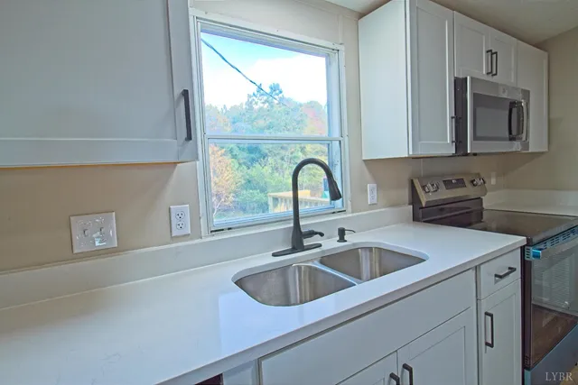 a kitchen with a sink cabinets and window