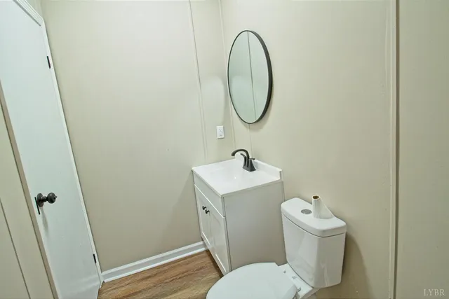a bathroom with a toilet a sink and a mirror