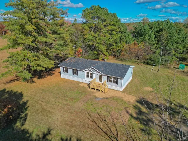 a aerial view of a house with a yard