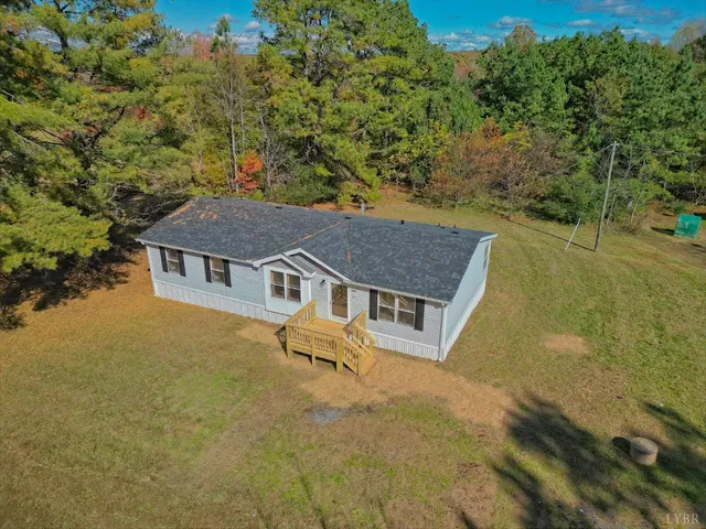 an aerial view of a house with a yard