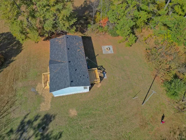an aerial view of a house with a yard
