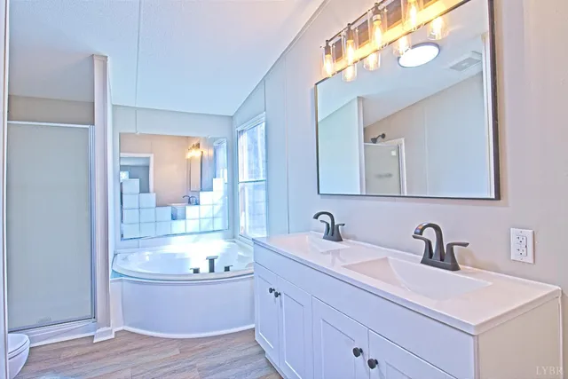 a bathroom with a tub sink and mirror