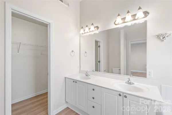 a bathroom with a double vanity sink and a mirror