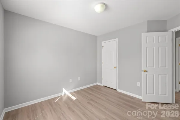 a view of wooden floor and windows in a room