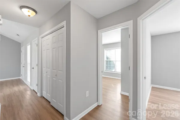a view of a hallway with wooden floor